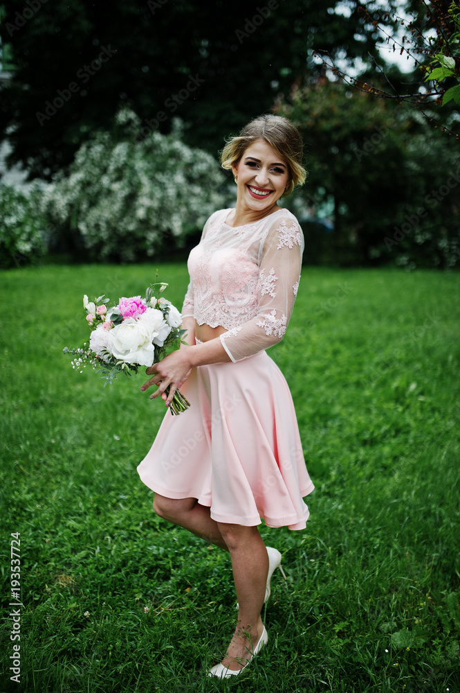 Perfect girl in pink dress with bouquet at hands. Perfect girl in pink dress with bouquet at hands.