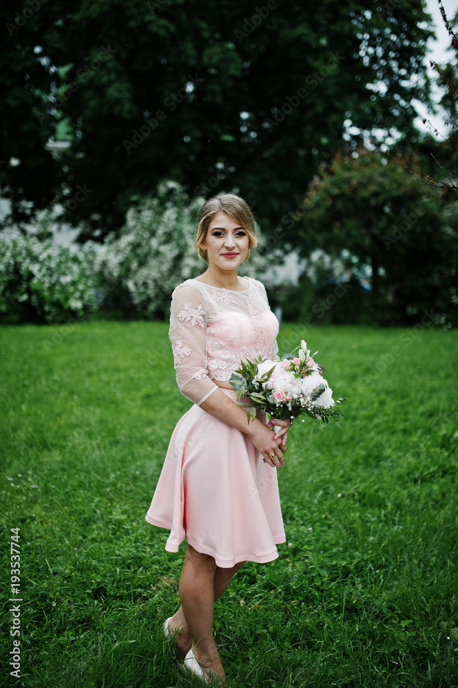 Perfect girl in pink dress with bouquet at hands. Perfect girl in pink dress with bouquet at hands.