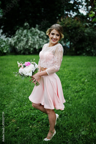 Perfect girl in pink dress with bouquet at hands. © AS Photo Family