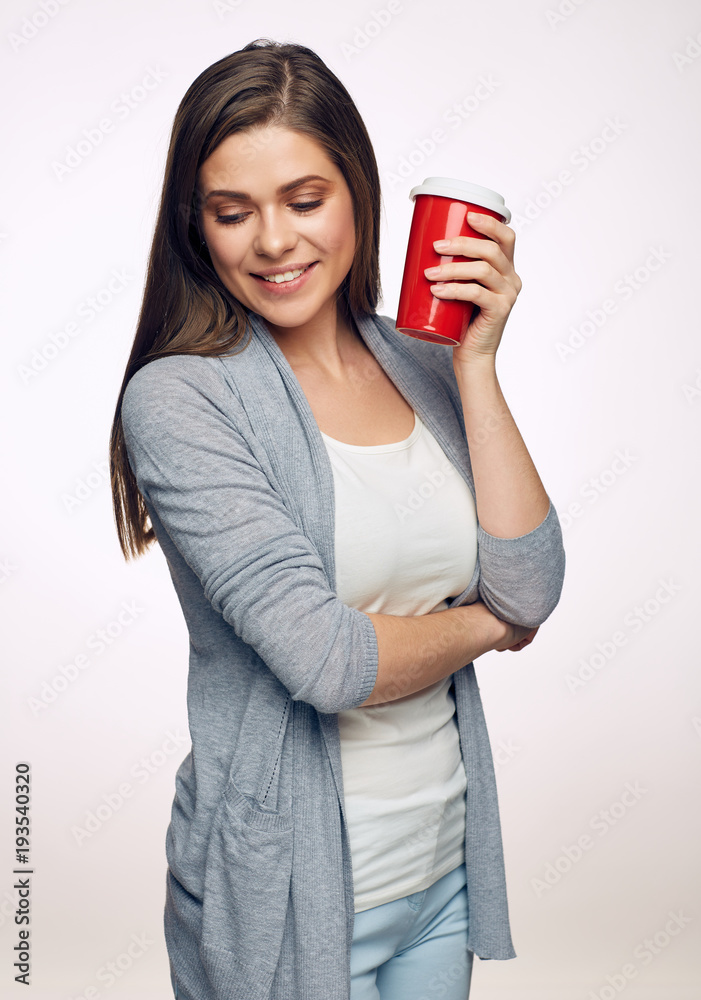Smilng woman holding red coffee cup looking down. Smilng woman holding red coffee cup looking down.