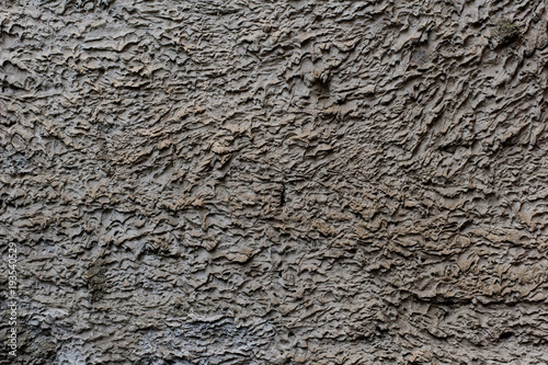 Background of a gray stucco coated and painted exterior  rough cast of cement and concrete wall texture  decorative coating