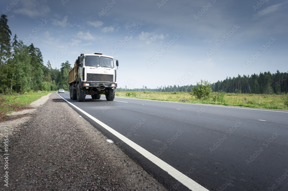 Truck transportation on the road at sunset Truck transportation on the road at sunset