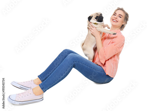 Young woman with cute pug d...