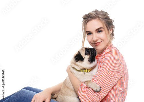 Young woman with cute pug d...