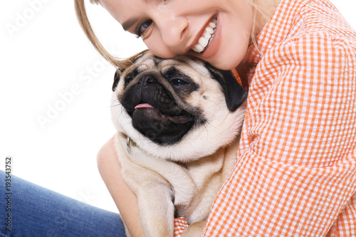 Young woman with cute pug d...