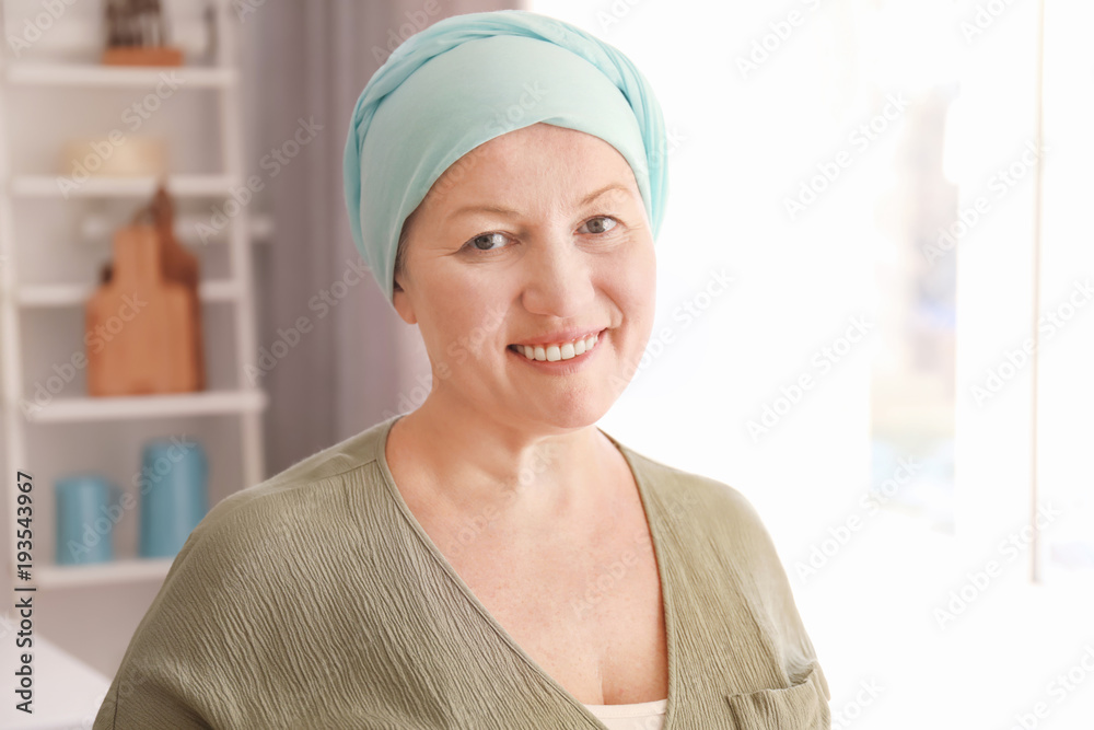 Mature woman with cancer in headscarf indoors Mature woman with cancer in headscarf indoors