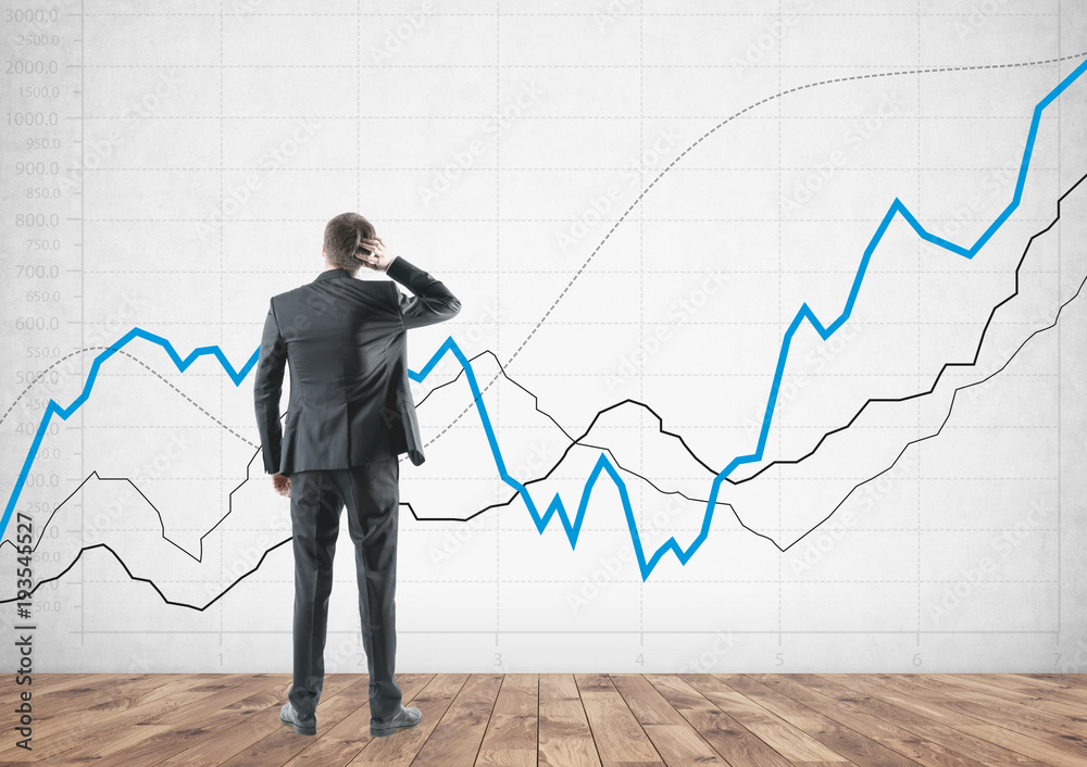 Rear view businessman scratching head, graph Rear view businessman scratching head, graph