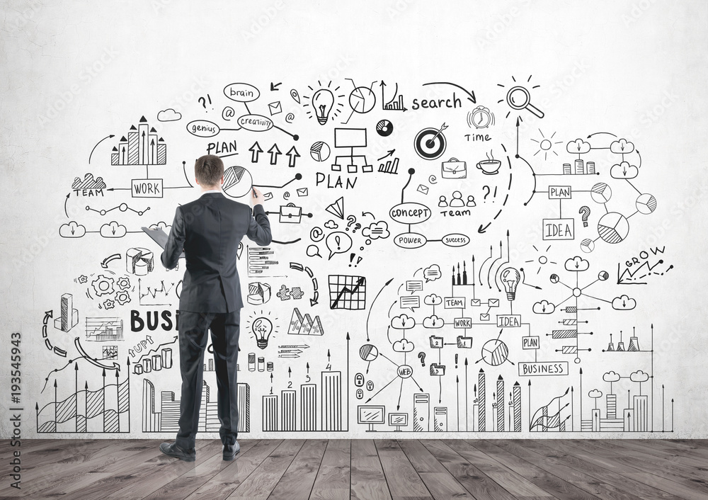 Rear view of a man drawing idea icons Rear view of a man drawing idea icons