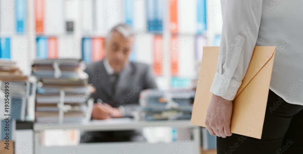 Secretary bringing an envelope to her boss
