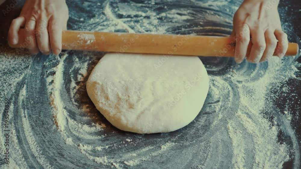Rolling dough with rolling pin for baking