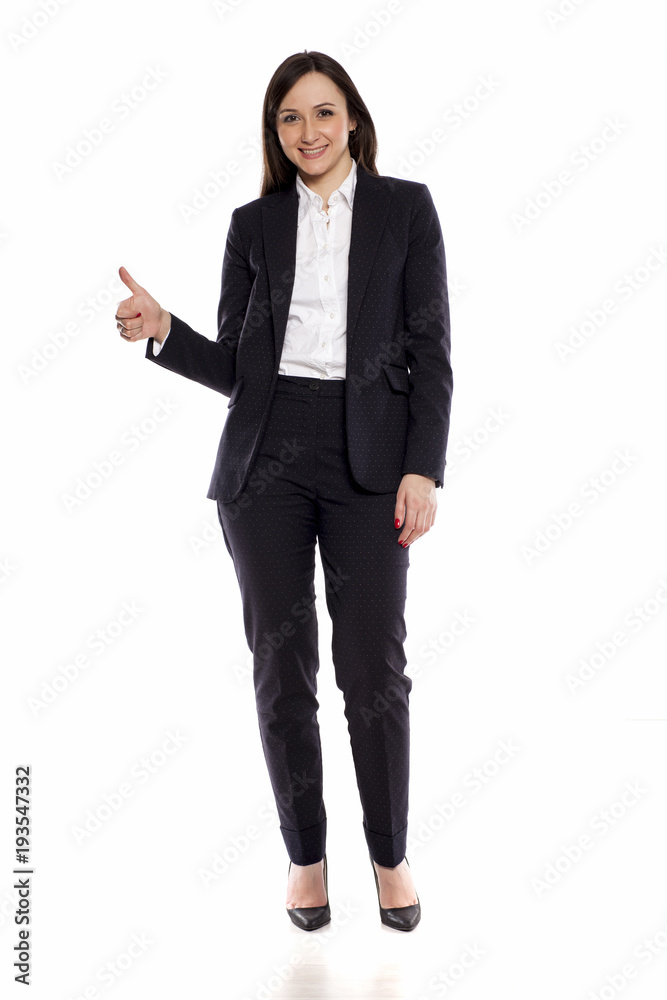 Smiling businesswoman with thumbs up standing on white background Smiling businesswoman with thumbs up standing on white background
