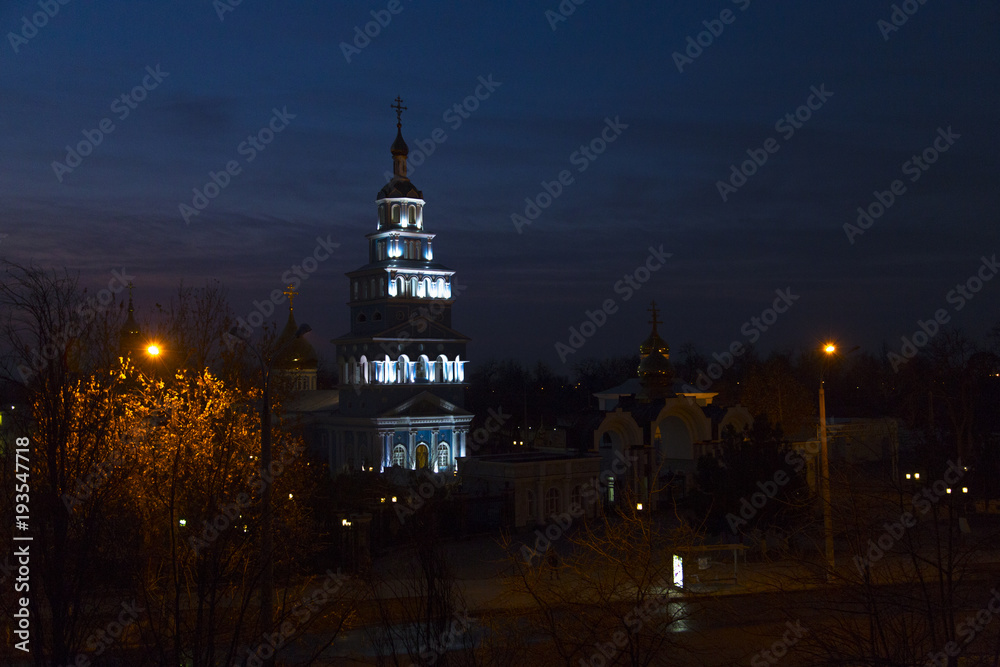 Orthodox church in background of sunrise between trees