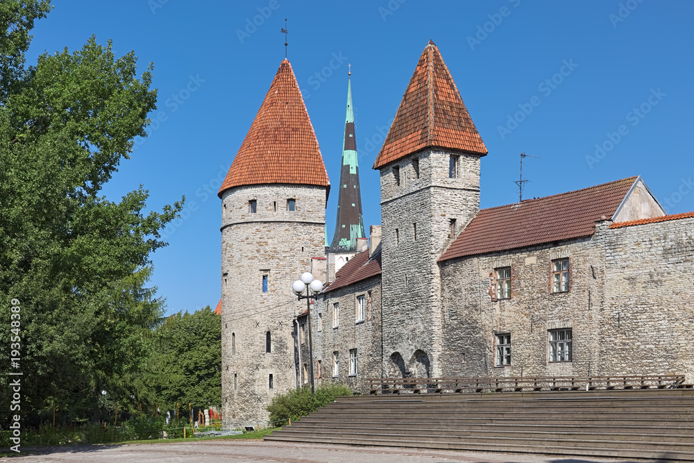Tallinn, Estonia. Loewenschede Tower and Nunnadetagune Tower (Tower behind Nuns) of the medieval city wall, and spire of St. Olaf's Church between them.