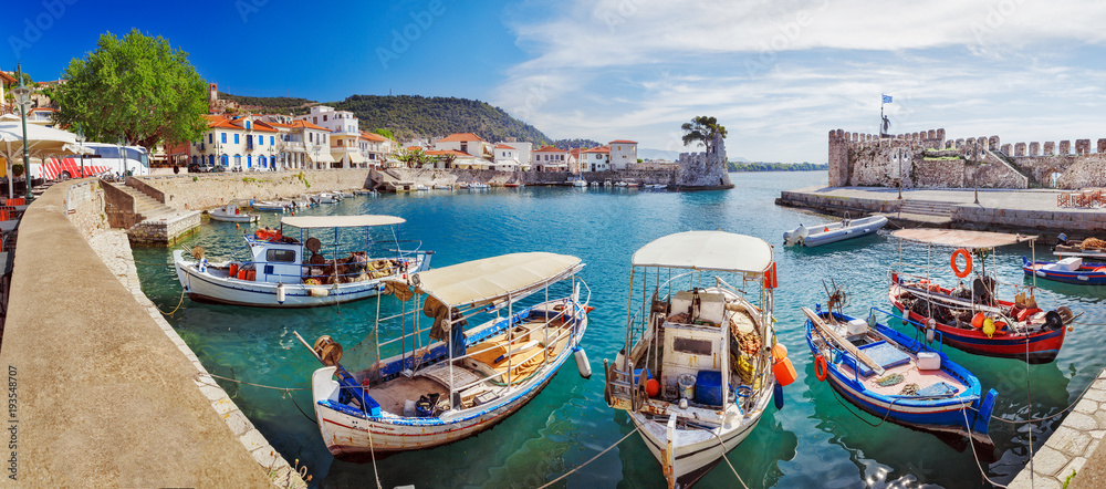 Greece, Europe. Scenic spring scenery of seafront of ancient Greek harbor Nafpaktos. Nafpaktos was important part of ancient Greece. Today Nafpaktos is popular iconic travel destination in Greece.