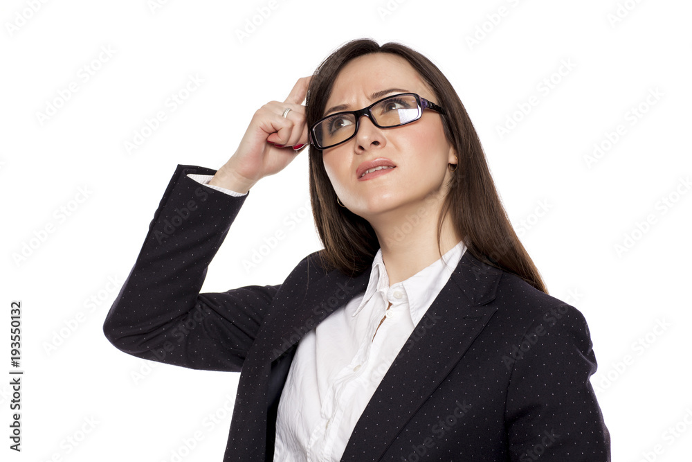 Confused businesswoman with questioning gesture posing on white background
