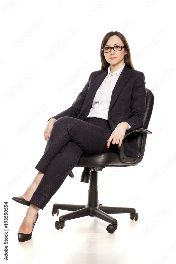 Positive businesswoman in armchair posing on white background Positive businesswoman in armchair posing on white background