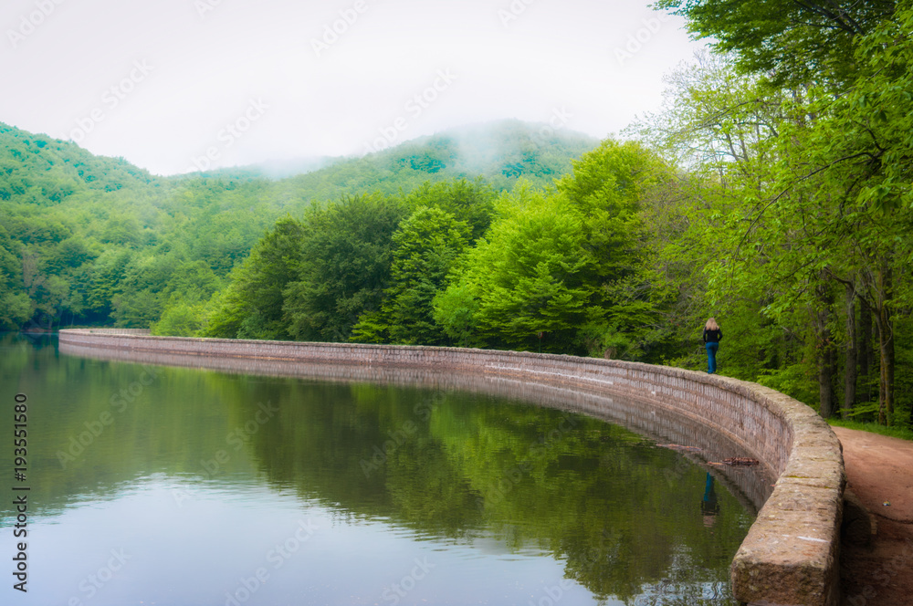 girl walking looking at the landscape in a lake girl walking looking at the landscape in a lake