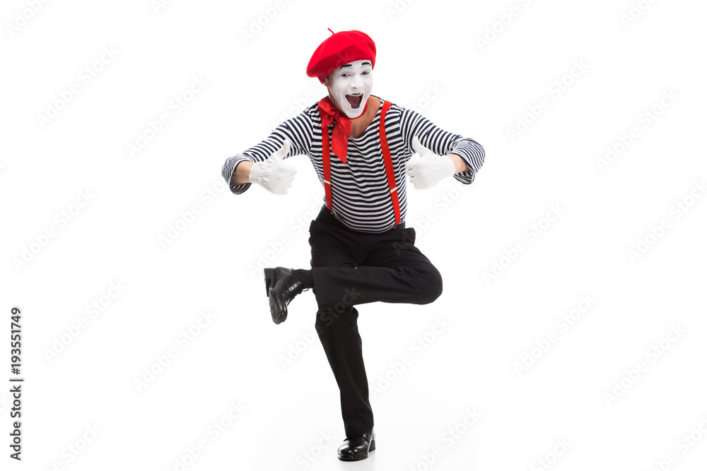funny mime performing on one leg and showing thumbs up isolated on white funny mime performing on one leg and showing thumbs up isolated on white