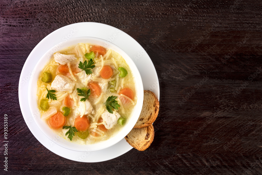 Chicken soup with noodles, overhead photo with copyspace Chicken soup with noodles, overhead photo with copyspace