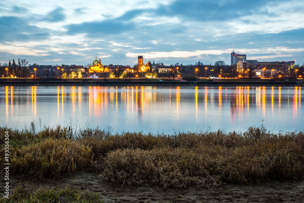 Night view on the Vistula river and church of the Visitation of the Virgin Mary in Warsaw, Poland