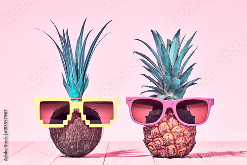Tropical Pineapple and Coconut. Bright Summer Color. Two Hipster Fruits in Trendy Sunglasses. Fashion Style. Creative Minimal. Hot Beach Vibes. Summer party Mood