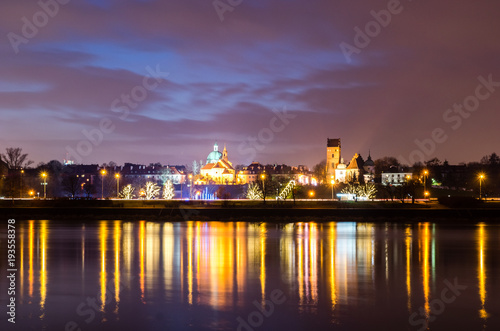 Night view on the Vistula river and church of the Visitation of the Virgin Mary in Warsaw, Poland
