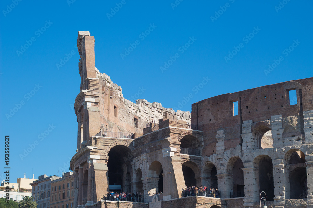 Part of the Coliseum full of tourists exploring inside. Rome, Italy.