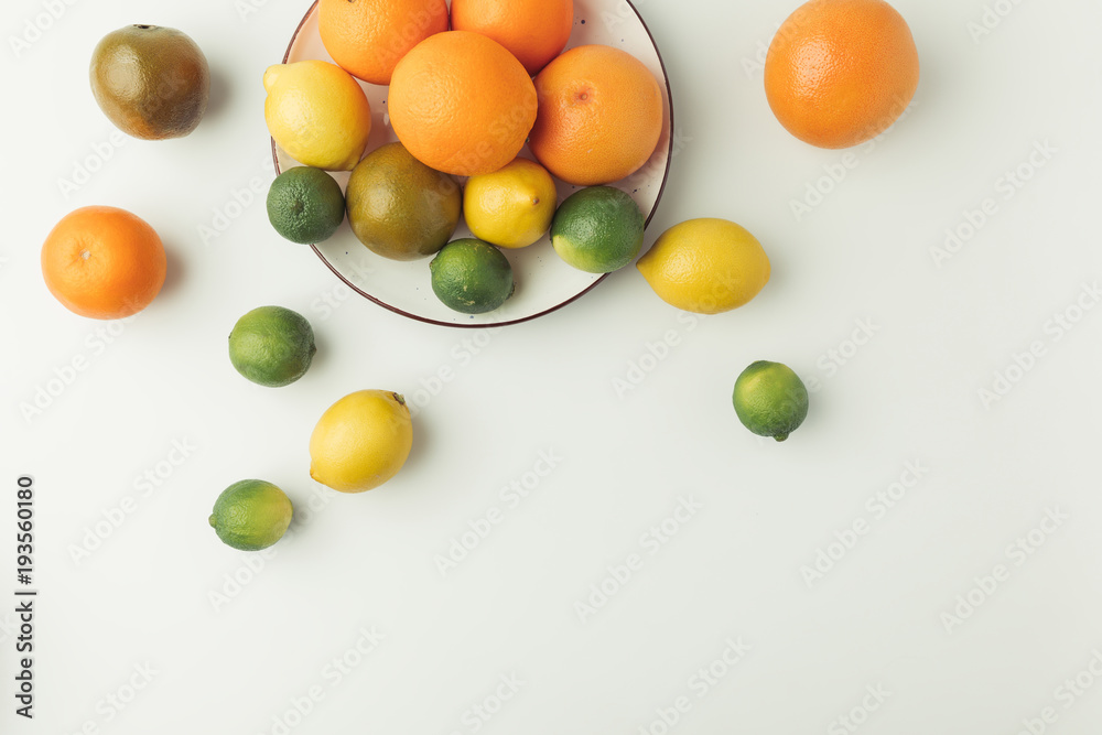 Citrus fruits on plate isolated on white background Citrus fruits on plate isolated on white background