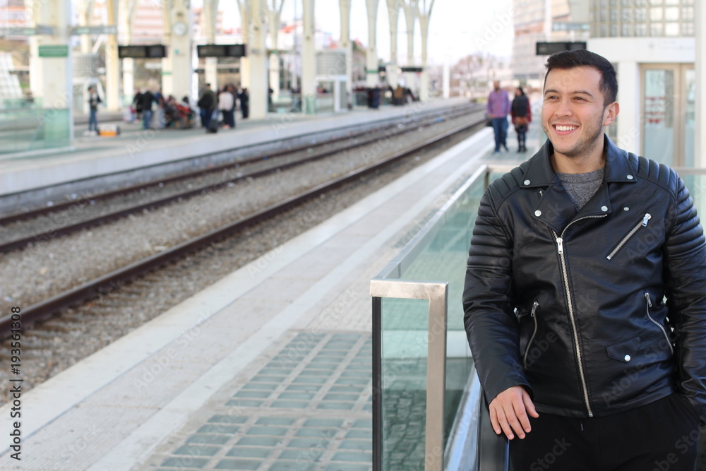 Smiley young ethnic male using public transportation