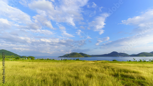 Beautiful scenery of Srinagarind Reservoir or Srinakharin dam with white clouds and blue sky in the morning , Kanchanaburi , Thailand