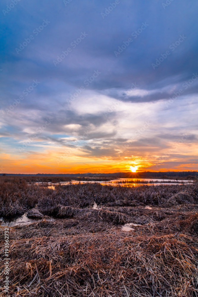 Sunset at Liberty Loop, part of the Wallkill River NWR, NJ, in late winter as the ice melts off the marshlands Sunset at Liberty Loop, part of the Wallkill River NWR, NJ, in late winter as the ice melts off the marshlands