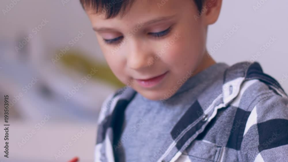Small boy drawing with ruler in copybook Small boy drawing with ruler in copybook