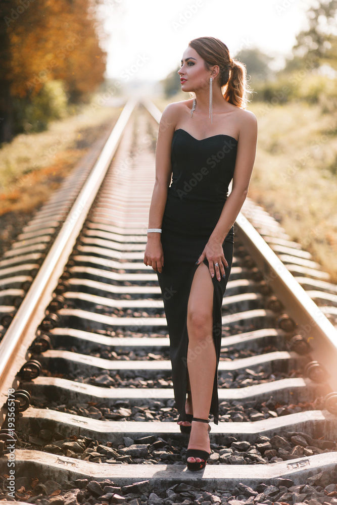 The charming girl stands on the track
