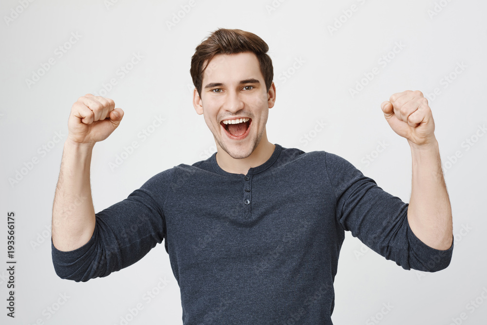 Portrait of cheerful dark-haired attractive European unshaven male ...