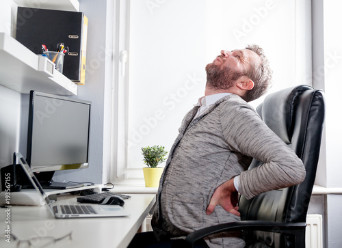 Man in office suffering from back pain