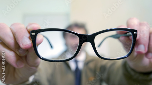 out of focus man behind glasses
