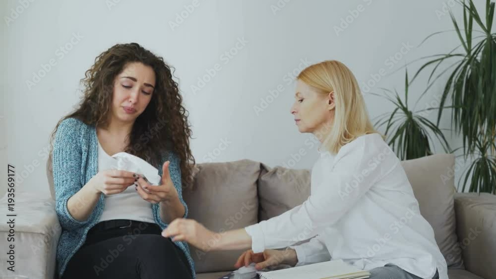 Woman Crying Interview Crying stressed woman talking with professional female psychologist who ...