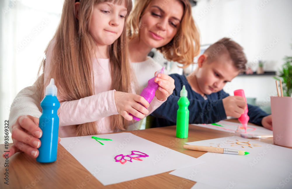 Happy loving family, mother with children together paint at home Happy loving family, mother with children together paint at home
