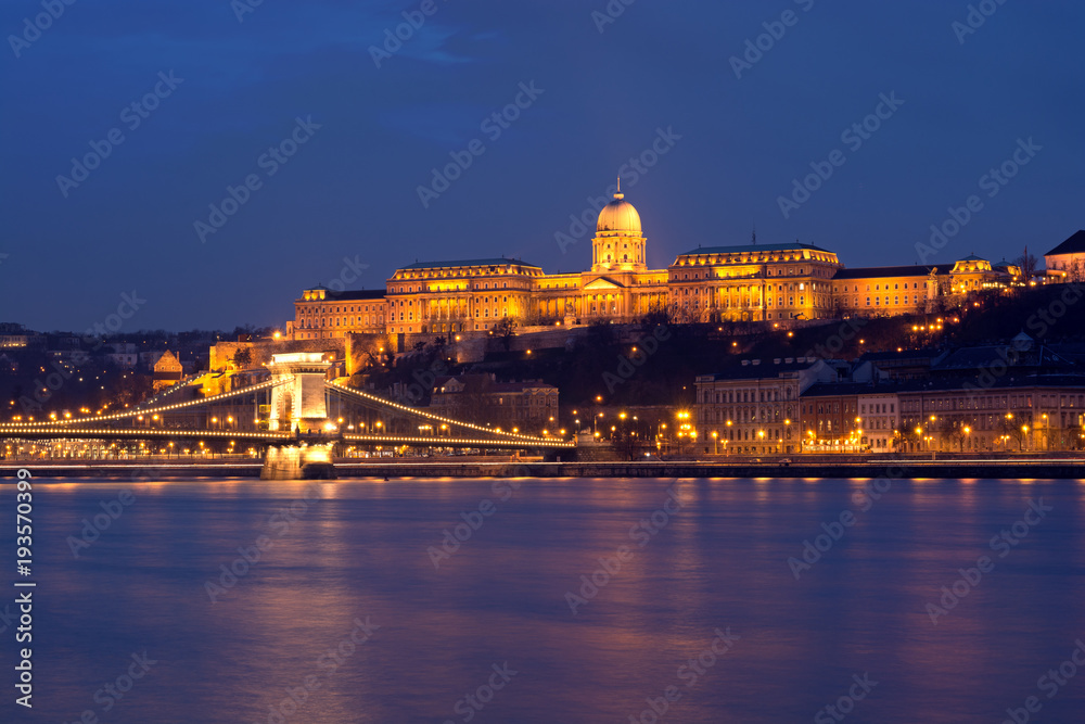 Illuminated Royal Palace in Budapest across Danube river at night