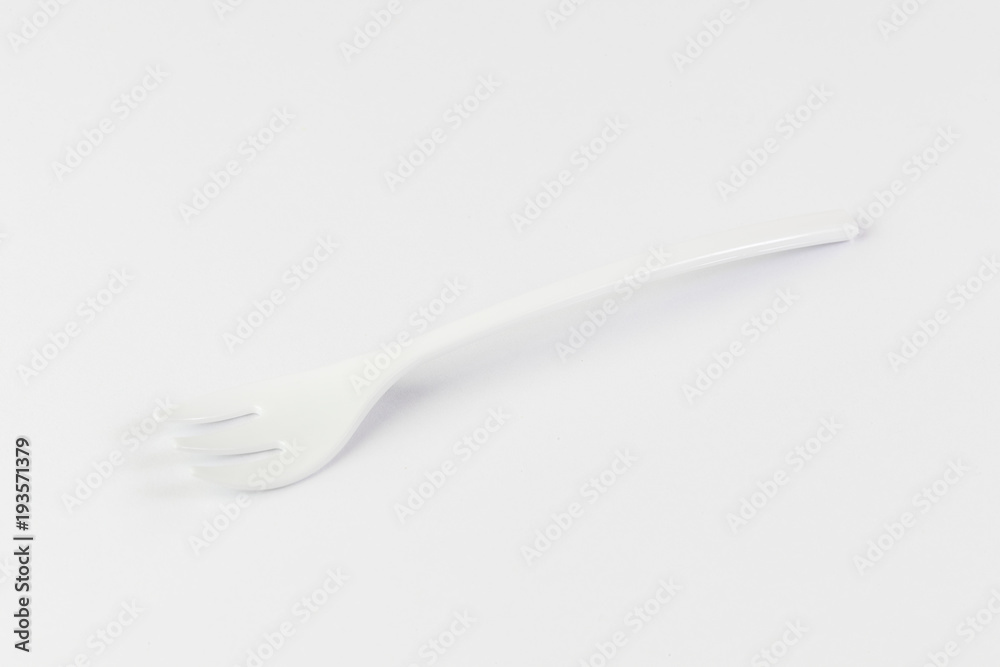Miniature plastic utensils for snacks and canaps on a white background Miniature plastic utensils for snacks and canaps on a white background