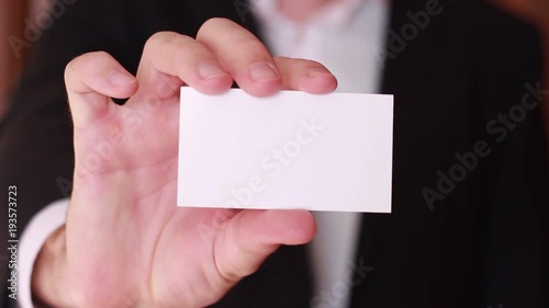 Blank business card showed by businessman