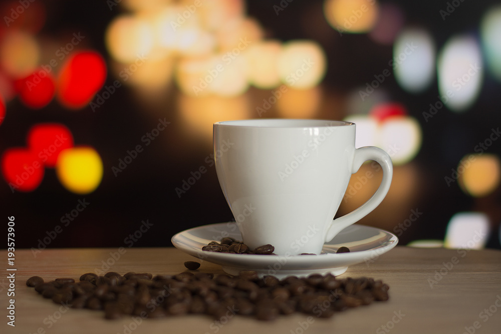 cup of coffee on wooden table with defocus bokeh of coffee shop background. Image with soft focus and blurred background. cup of coffee on wooden table with defocus bokeh of coffee shop background. Image with soft focus and blurred background.