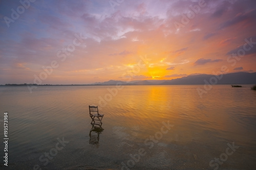 sunset view with a chair in the water