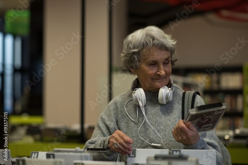 Senior woman choosing a dvd cassette photo