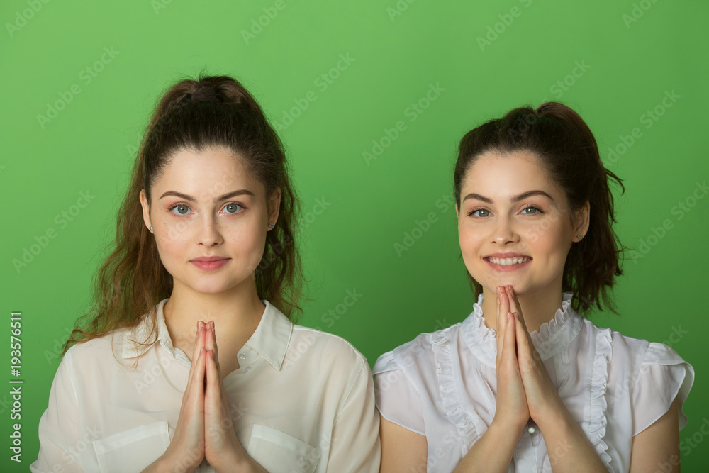 two beautiful positive girls with joyful emotions on a green background two beautiful positive girls with joyful emotions on a green background