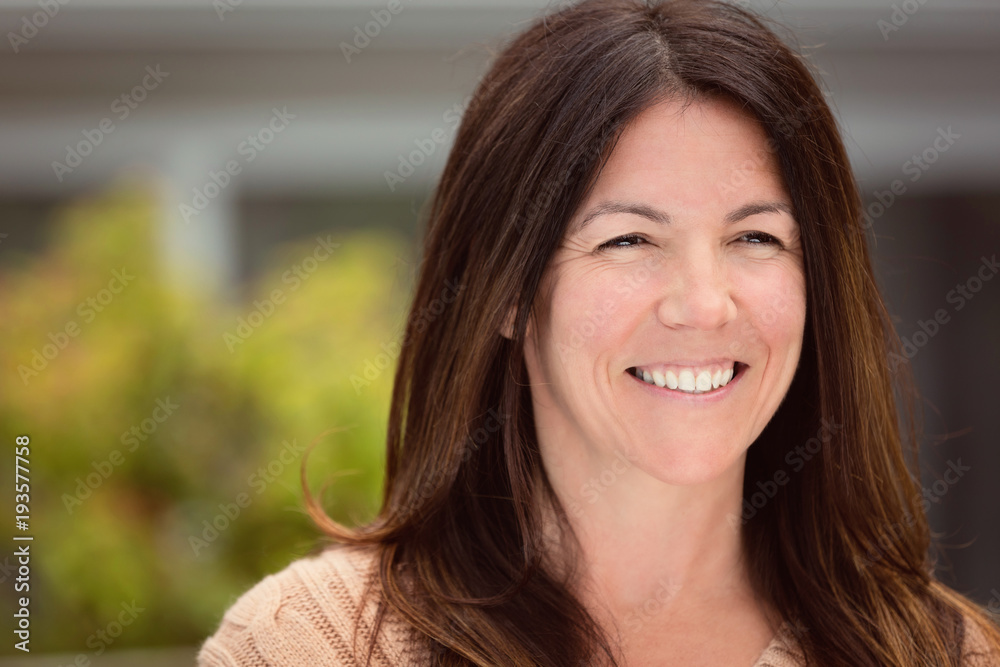Mature woman smiling outside Mature woman smiling outside