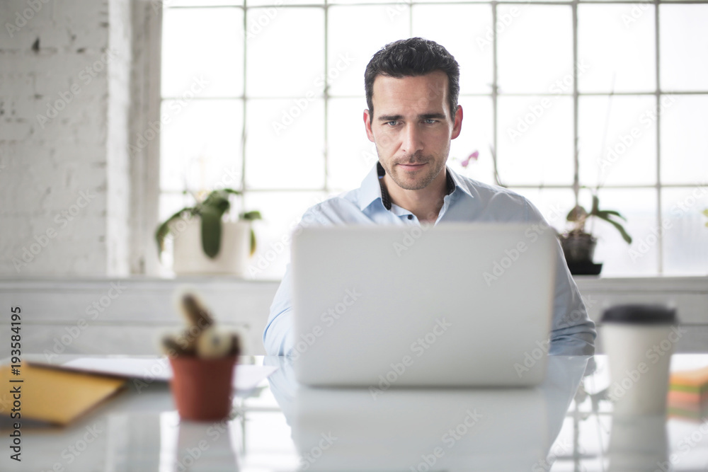 © merla - Man checking his phone while waiting on a bridge