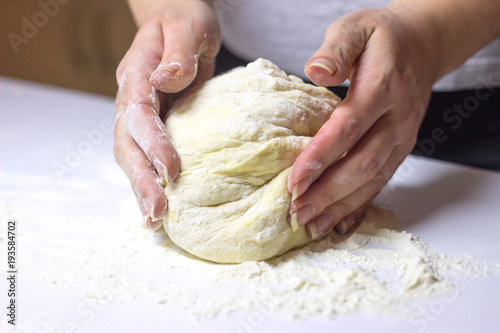 Beautiful woman hands making dough
