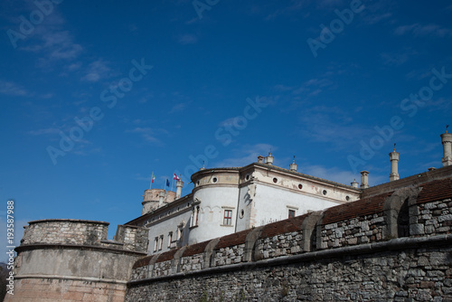 The castle originated from a fortified building that was erected in the 13th century next to the city's walls.