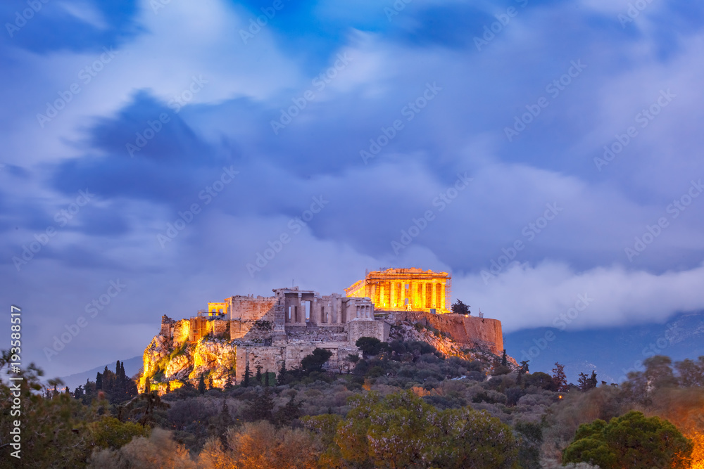 Fototapeta premium Aerial view of the Acropolis Hill, crowned with Parthenon during evening blue hour in Athens, Greece